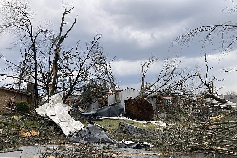 A homs is damaged and trees are down after a tornado swept through Little Rock, Ark., Friday, March 31, 2023. (AP Photo/Andrew DeMillo)