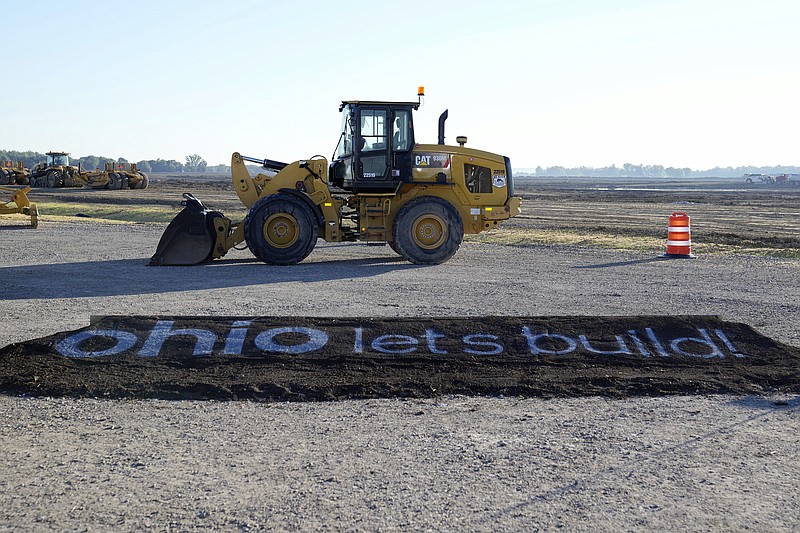 FILE - A bulldozer is displayed during a groundbreaking ceremony for Intel's $20 billion microchip manufacturing project, Sept. 9, 2022, in New Albany, Ohio. States are giving out more cash than ever before to multibillion-dollar microchip foundries and electric vehicle and battery factories, inspiring ever-more competition as states dig deeper into their pockets to attract big employers and capitalize on a wave of huge new projects. (Adam Cairns/The Columbus Dispatch via AP)