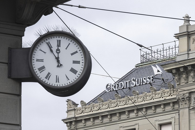 FILE - A clock next to a logo of the Swiss bank Credit Suisse, in Zurich, Switzerland, on March 20, 2023. Analysts say the UBS takeover of embattled rival Credit Suisse has shaken Switzerland’s self-image and dented its reputation as a global financial center. They warn that the country’s prosperity could grow too dependent on a single banking behemoth. (Ennio Leanza/Keystone via AP, File)