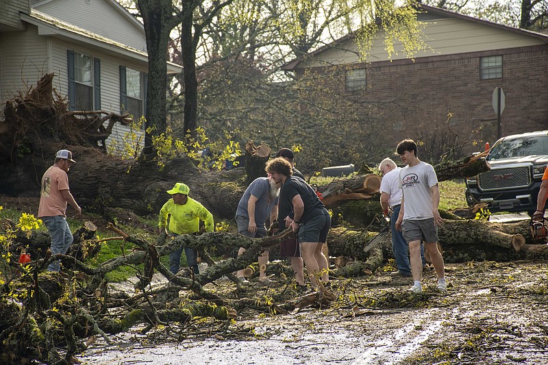 Residents help clear fallen trees in North Little Rock after the area was hit by a tornado on Friday, March 31, 2023 (Arkansas Democrat-Gazette/Cary Jenkins)