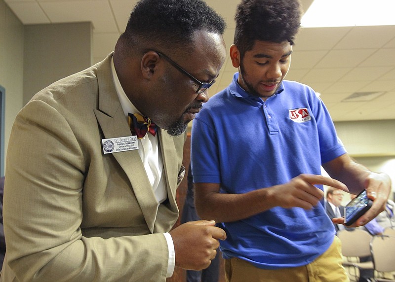 Jalen Sereal (right), then a student at LISA Academy North, shows Jeremy Owoh a solar car project in this Feb. 15, 2018 file photo. Sereal and other LISA Academy students were building the car. Owoh, who was then the assistant commissioner on the Arkansas Department of Education's Charter Authorizing Panel, later became the superintendent of the Jacksonville North Pulaski School District. (Arkansas Democrat-Gazette file photo)