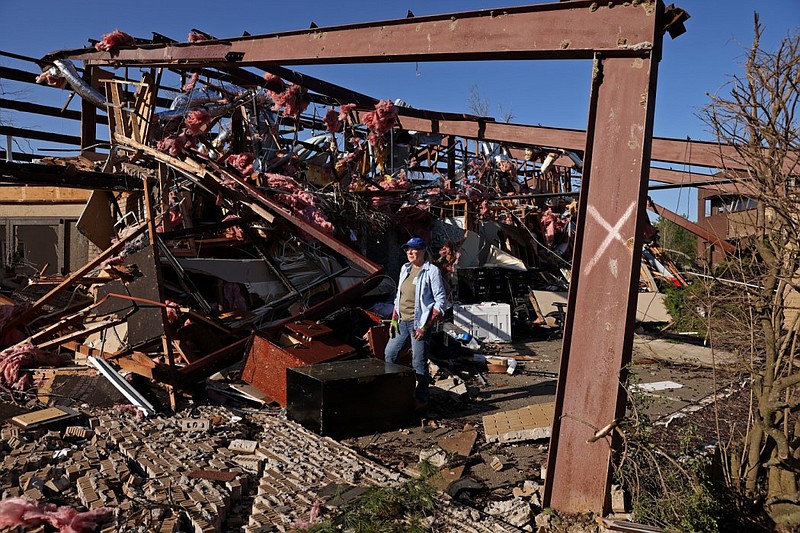 Anne Fuller stands in what was left of her business at 9 Shackleford Plaza in the Walnut Valley neighborhood of West Little Rock on Saturday, April 1, 2023 after a tornado struck the area a day earlier, on Friday, March 31. (Arkansas Democrat-Gazette/Colin Murphey)