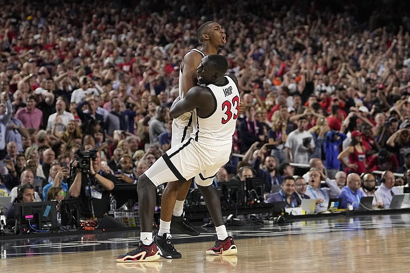 San Diego State guard Lamont Butler (left) celebrates with forward Aguek Arop after making the game-winning shot Saturday night against Florida Atlantic in the Final Four at NRG Stadium in Houston. The Aztecs defeated the Owls 72-71 to advance to their first national championship game Monday night. More photos at arkansasonline.com/42final4/
(AP/David J. Phillip)