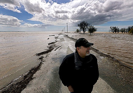 Agricultural consultant Mark Grewal stands on a flooded farm road near Corcoran, Calif., where Tulare Lake is reappearing and inundating thousands of acres of farmland. “This is unreal,” said Grewal, who has worked on the area’s farms since 1979. “I’m just amazed at how fast it filled.”
(Los Angeles Times/TNS/Luis Sinco)