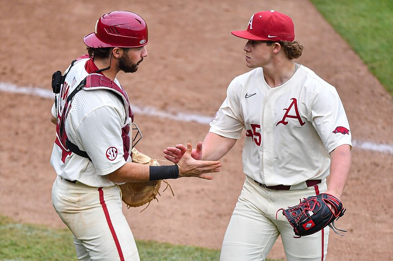 Arkansas catcher Parker Rowland (44) celebrates with relief pitcher Gage Wood (45), Sunday, April 2, 2023, during the eighth inning of the Razorbacks’ 5-4 series-clinching win over Alabama at Baum-Walker Stadium in Fayetteville. Visit nwaonline.com/photo for the photo gallery.