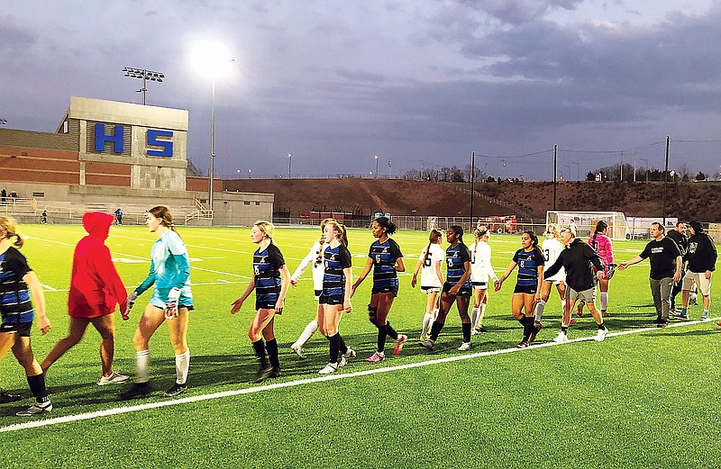 The Capital City Lady Cavaliers go through the handshake line after Friday night's soccer win against the Branson Lady Pirates at Capital City High School. (Tom Rackers/News Tribune)