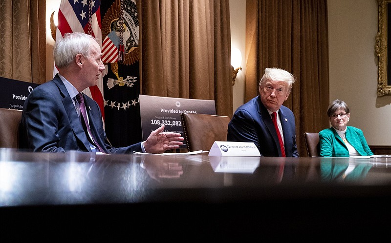 President Donald Trump meets with Arkansas Gov. Asa Hutchinson, left, and Kansas Gov. Laura Kelly, at the White House in Washington, Wednesday, May 20, 2020. (Doug Mills/The New York Times)