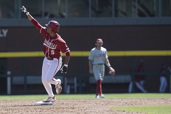 Arkansas designated hitter Kendall Diggs rounds second base after hitting a home run during a game against Alabama on Saturday, April 1, 2023, in Fayetteville.