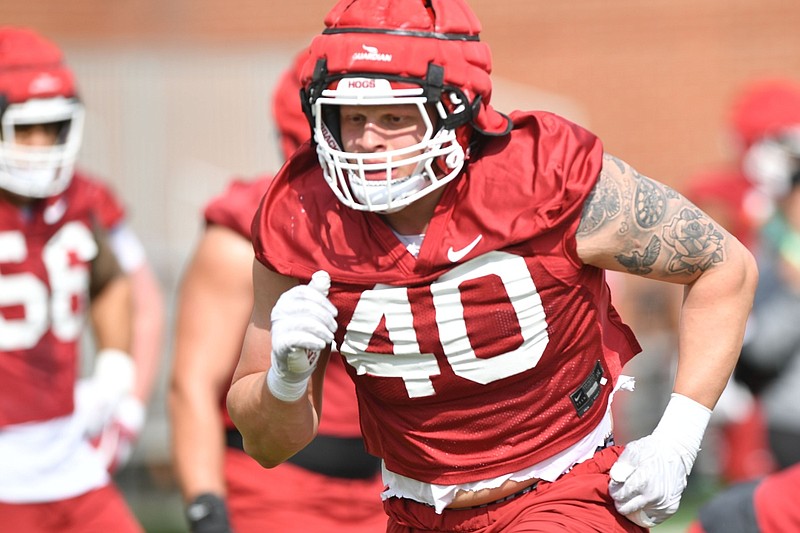 Arkansas defensive lineman Landon Jackson runs through a drill Thursday, March 30, 2023, during practice at the university practice facility in Fayetteville.