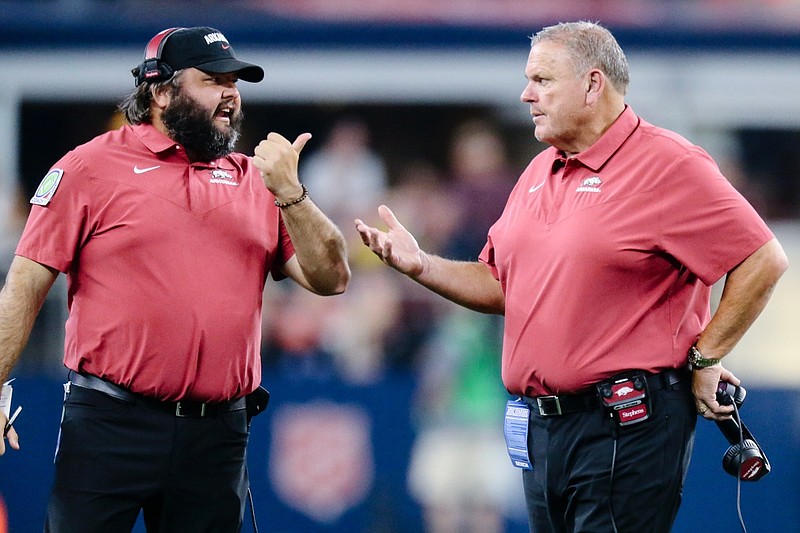 Arkansas head coach Sam Pittman talks to offensive line coach Cody Kennedy, Saturday, September 23, 2022 during the second quarter of a football game at AT&T Stadium in Arlington, Texas.