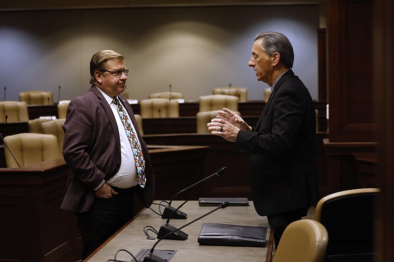 Arkansas state Rep. Mark Perry (left), D-Jacksonville, talks with A.J. Gary, director of the Arkansas Department of Emergency Management, on Thursday, April 6, 2023, at the state Capitol in Little Rock after Gary gave an update to legislators about the previous week's tornadoes. (Arkansas Democrat-Gazette/Thomas Metthe)