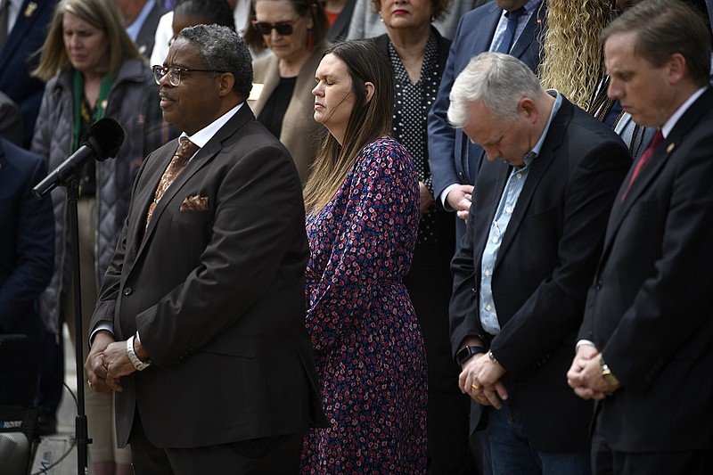Pastor Eddie Miller (left) from the New Commandment Church of God in Christ in Wynne leads a prayer on the steps of the state Capitol in Little Rock on Friday. Gov. Sarah Huckabee Sanders stood with members of the House of Representatives and others for a moment of silence for the lives lost and others affected by the tornadoes that hit the state on March 31.
(Arkansas Democrat-Gazette/Stephen Swofford)