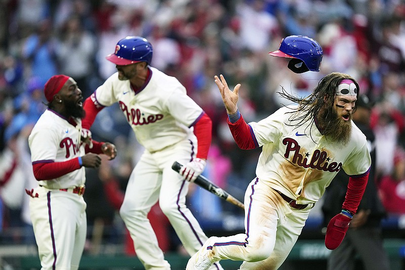 Brandon Marsh of the Phillies celebrates after scoring the game-winning run in the bottom of the ninth inning in Saturday's game against the Reds in Philadelphia. (Associated Press)