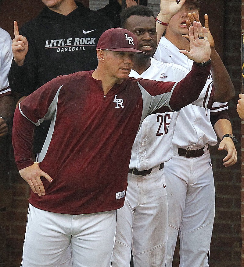 Arkansas Democrat-Gazette/THOMAS METTHE -- 5/3/2018 --.UALR head coach Chris Curry (right) congratulates Nick Perez after he scored in the bottom of the third inning of the Trojans' game against South Alabama on Friday, May 4, 2018, at Gary Hogan Field in Little Rock.