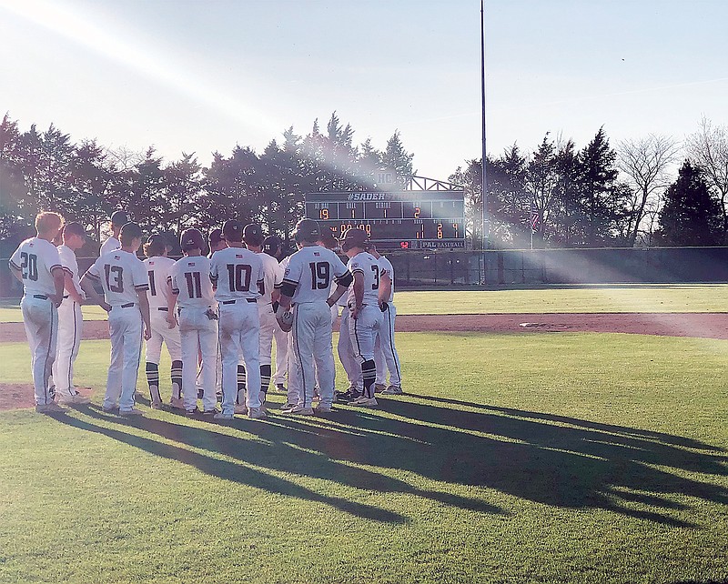 The Helias Crusaders meet near the mound after Tuesday's win against the Owensville Dutchmen at the American Legion Post 5 Sports Complex. (Tom Rackers/News Tribune)