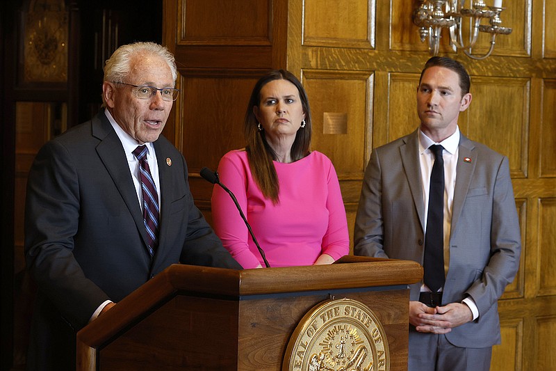 Rep. Jon Eubanks (left), R-Paris, answers questions as Gov. Sarah Huckabee Sanders and Sen. Tyler Dees, R-Siloam Springs, look on at the state Capitol in Little Rock on Wednesday after Sanders signed a bill aimed at restricting children’s access to social media sites.
(Arkansas Democrat-Gazette/Thomas Metthe)