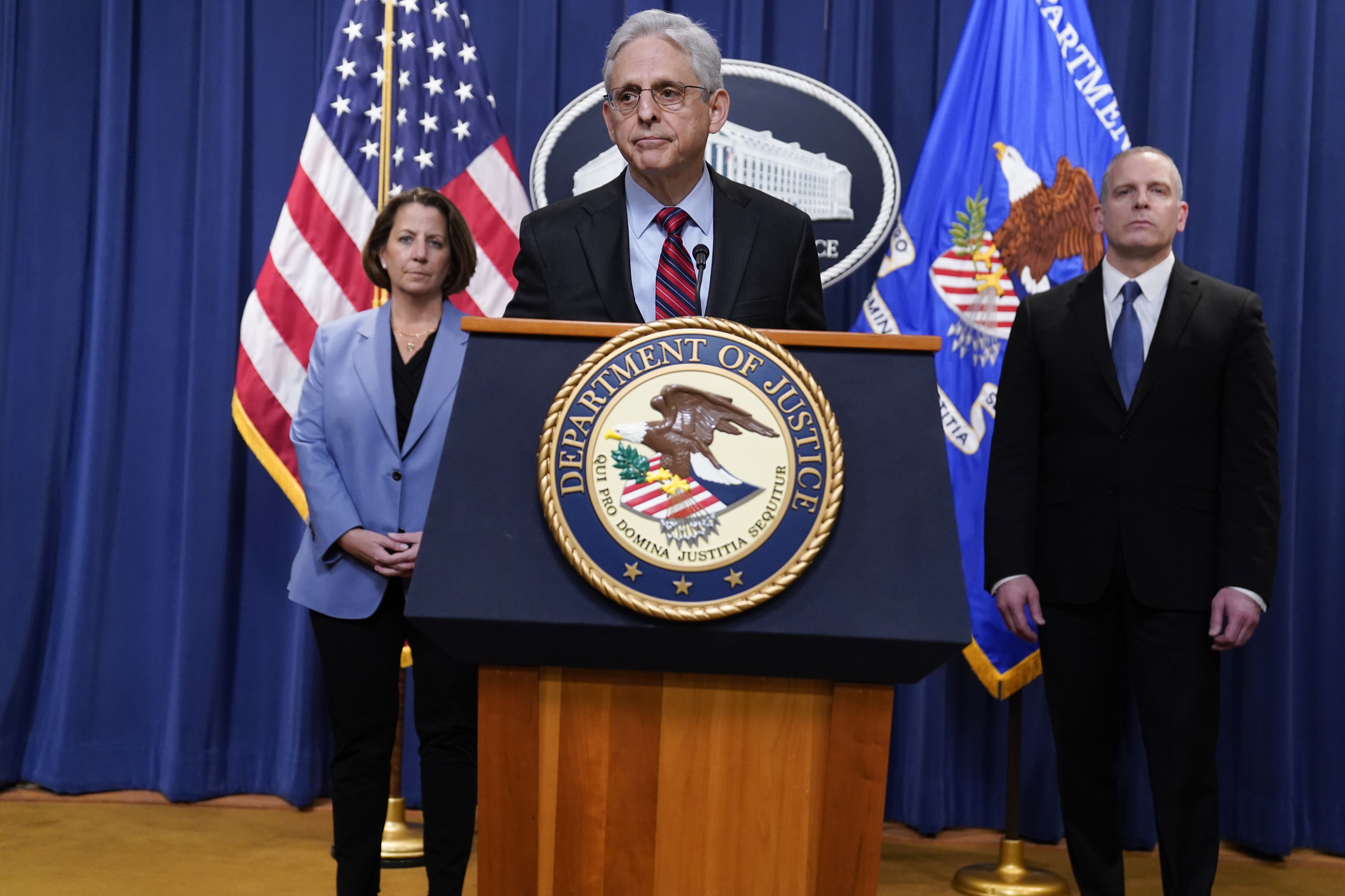 Attorney General Merrick Garland speaks at the Department of Justice in Washington, Thursday, April 13, 2023. FBI Deputy Director Paul Abbate, right, and Deputy Attorney General Lisa Monaco, left, listen. (AP Photo/Evan Vucci)