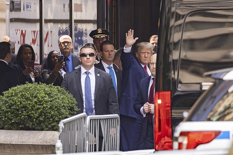 Former President Donald Trump waves as he leaves Trump Tower in New York on Friday.
(AP/Yuki Iwamura)