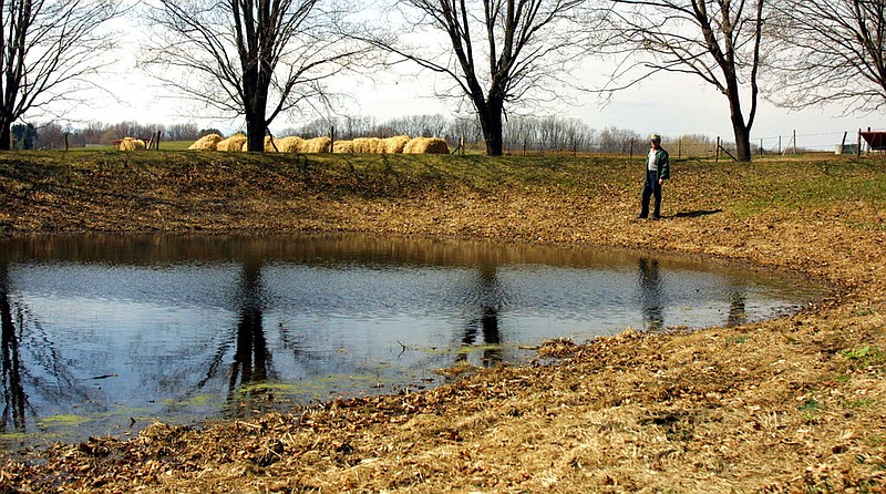 Dairy farmer Paul Peter stands by his emergency pond near his house at Castleton-on-Hudson, N.Y., in this April 2, 2002 file photo. The Environmental Protection Agency's rule defining waters of the United States seeks to clarify which waters or wetlands would trigger federal requirements such as permitting and state water quality certification. Seasonal and rain-dependent streams, as well as wetlands near rivers and streams, would be covered; others would be considered on a case-by-case basis to determine if they play a significant role in the quality of downstream waters. Landowners and developers say the government has gone too far in regulating isolated ponds or marshes with no direct connection to navigable waterways. (AP/Jim McKnight)