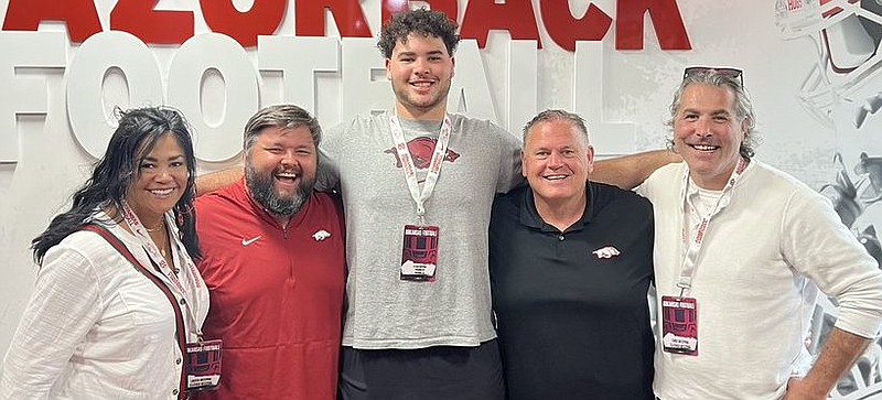 Consensus 4-star offensive lineman Fletcher Westphal and his parents, Libby and Chris, with Arkansas coach Sam Pittman and offensive line coach Cody Kennedy