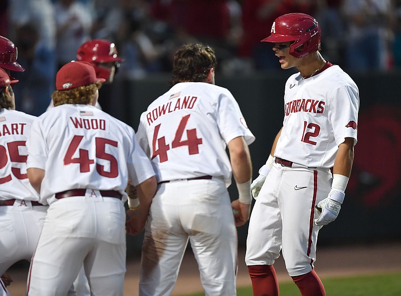 Arkansas center fielder Tavian Josenberger (12) celebrates Friday, April 14, 2023, after hitting a two-run home run scoring shortstop John Bolton during the third inning against Tennessee at Baum-Walker Stadium in Fayetteville. Visit nwaonline.com/photo for today's photo gallery. .(NWA Democrat-Gazette/Andy Shupe)