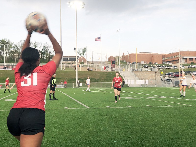 Jefferson City's Stasha Deters throws the ball in to Lady Jays teammate Katie Mullen during the first half of Tuesday night's match against the Hickman Kewpies at Jefferson City High School. (Tom Rackers/News Tribune)