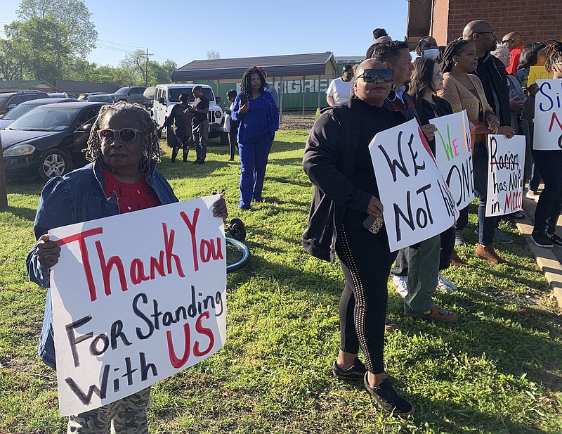 Glenda Austin of Idabel, Okla., holds a sign with other protesters outside the McCurtain County Commissioners meeting room Monday in Idabel, Okla.
(The Texarkana Gazette/Lori Dunn)