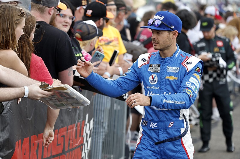 Kyle Larson signs autographs Sunday, April 16, 2023, at Martinsville Speedway. Larson won for the first time in Martinsville for his second victory in the last three races on Sunday. (Courtesy Getty Images and NASCAR Media)