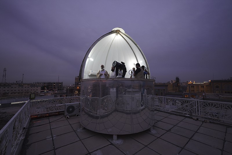 Shiites observe the crescent moon to determine the start of the tenth Islamic month of Shawwal, which marks the end of a month-long fasting of Ramadan and the beginning of the Eid al-Fitr festival in Najaf, Iraq, Thursday, April 20, 2023. (AP Photo/Anmar Khalil)