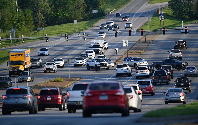 Traffic moves through the intersection of Joyce Boulevard and College Avenue in Fayetteville in this May 12, 2022 file photo. A Regional Planning committee on Thursday, April 20, 2023 recommended approval of two traffic management programs aimed at managing congestion and making roads safer for drivers, bicyclists and pedestrians in Northwest Arkansas. (NWA Democrat-Gazette/Andy Shupe)