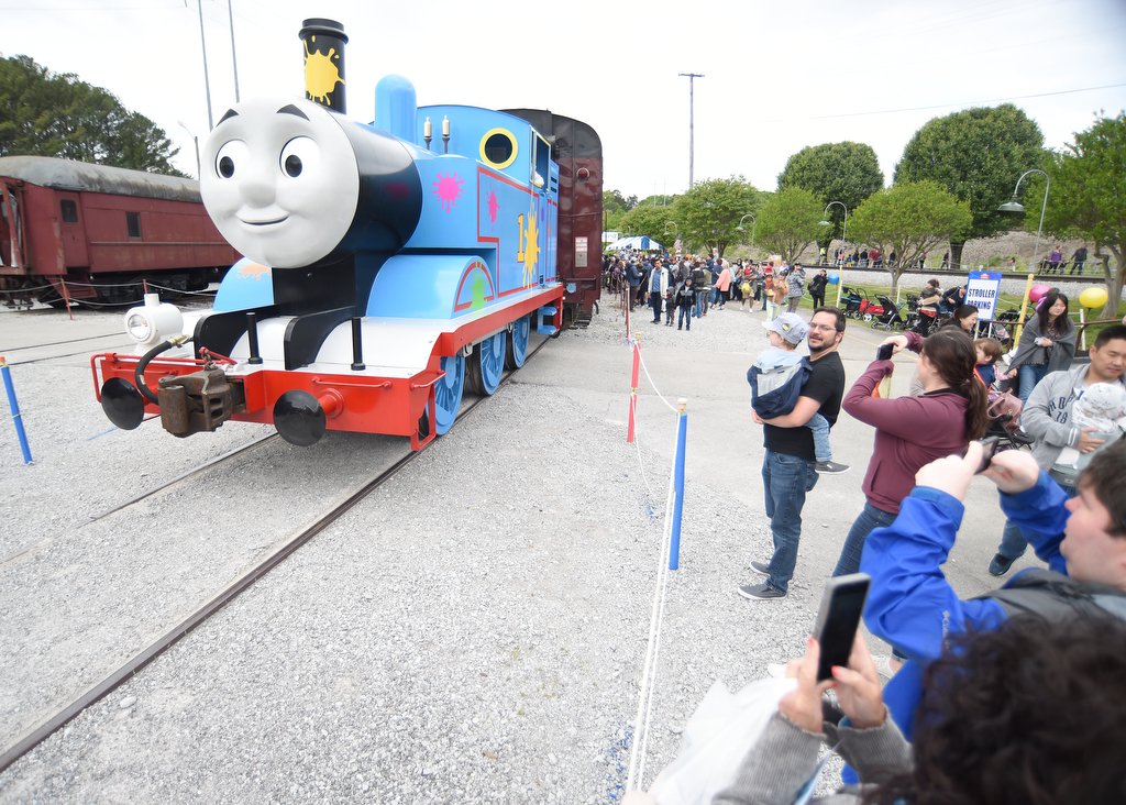 Staff photo by Matt Hamilton /  Visitors take pictures as the life-size Thomas the Tank Engine rolls in to the station during the Day Out With Thomas at the Tennessee Valley Railroad Museum on Sunday, April 23, 2023.