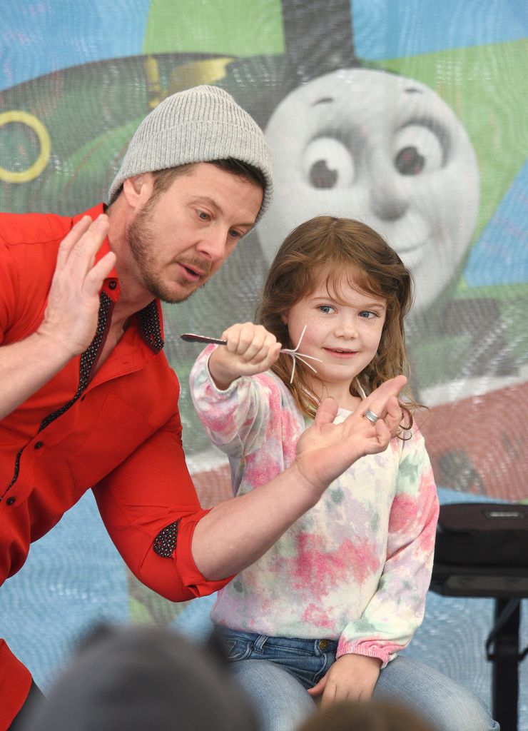 Staff photo by Matt Hamilton / Illusionist Jaden Maxwell performs a trick with help from Buford, Ga. Resident Katherine Buchanan, 7, during the Day Out With Thomas at the Tennessee Valley Railroad Museum on Sunday, April 23, 2023.