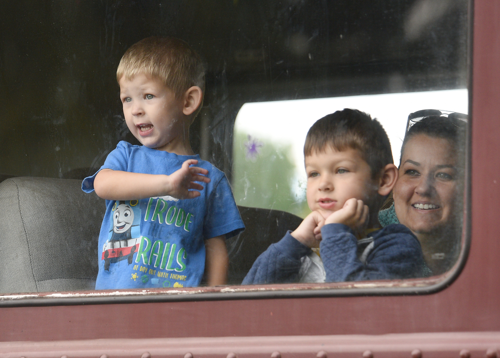Staff photo by Matt Hamilton / Chattanooga residents Wyatt Hunsucker, 2, and Eli Hunsucker, 5, wave and look out the window of their train during the Day Out With Thomas at the Tennessee Valley Railroad Museum on Sunday, April 23, 2023.
