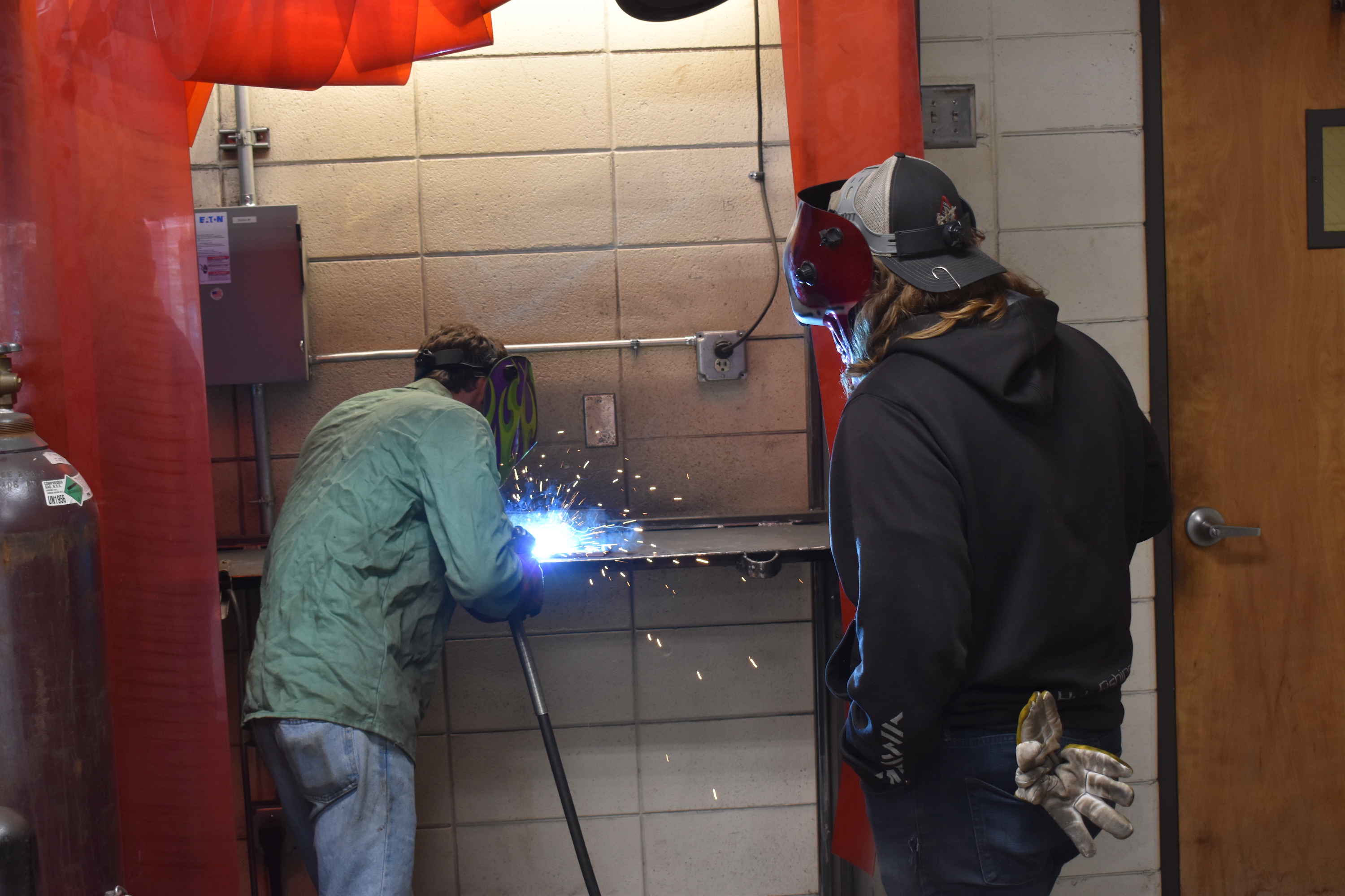 Staff Photo by Andrew Wilkins / A student in the Walker County school district's Launch program, Jacob Broome, gives a welding demonstration while fellow student Jonathan Bullard observes Thursday.