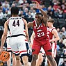 Arkansas guard Derrian Ford (23) covers Connecticut guard Andre Jackson Jr. (44), Thursday, March 23, 2023 during the second half of the NCAA Division I Basketball Championship Sweet 16 Round at T-Mobile Arena in Las Vegas, Nev. Visit nwaonline.com/photos for the photo gallery.