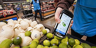 A worker scans onions, limes and other produce in the Walmart Supercenter in North Bergen, N.J., in February.
(AP)
