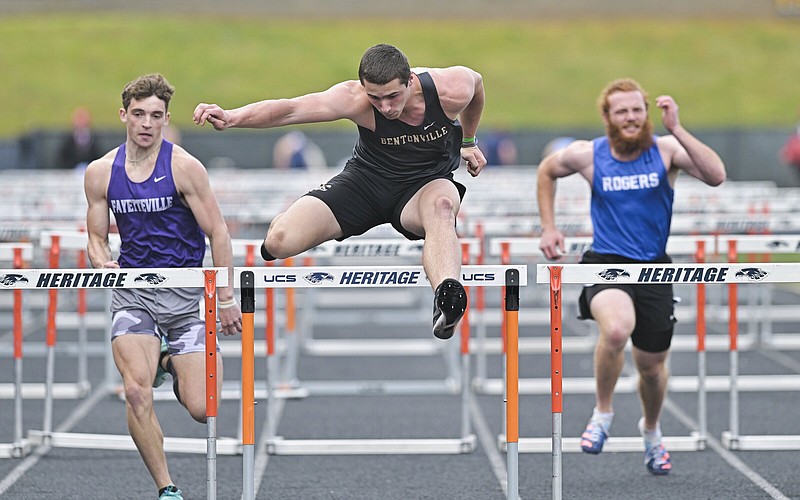 Bentonville’s Eli Brooks competes in the boys 110-meter hurdles during the 6A-West Conference meet Thursday at Heritage High School in Rogers.
(NWA Democrat-Gazette/Charlie Kaijo)