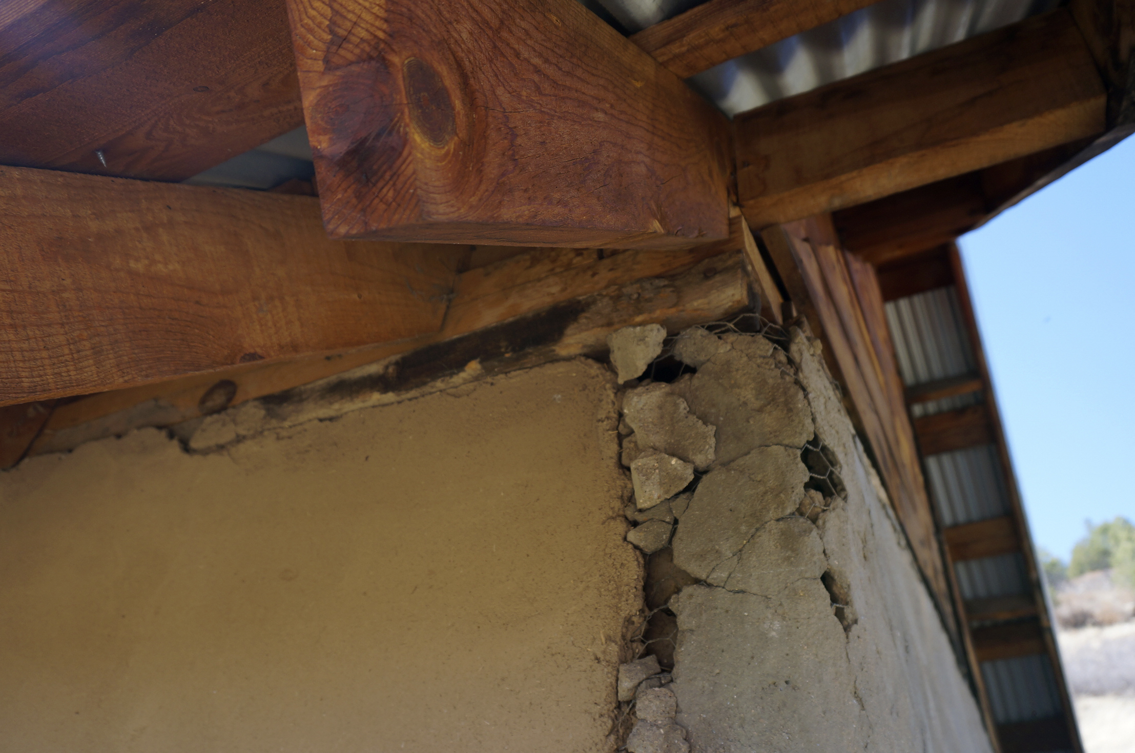 Cracks appear where the preserved adobe wall abuts a cement addition on the 1860s San Isidro chapel near the hamlet of Holman, New Mexico, Saturday, April 15, 2023. The chapel or