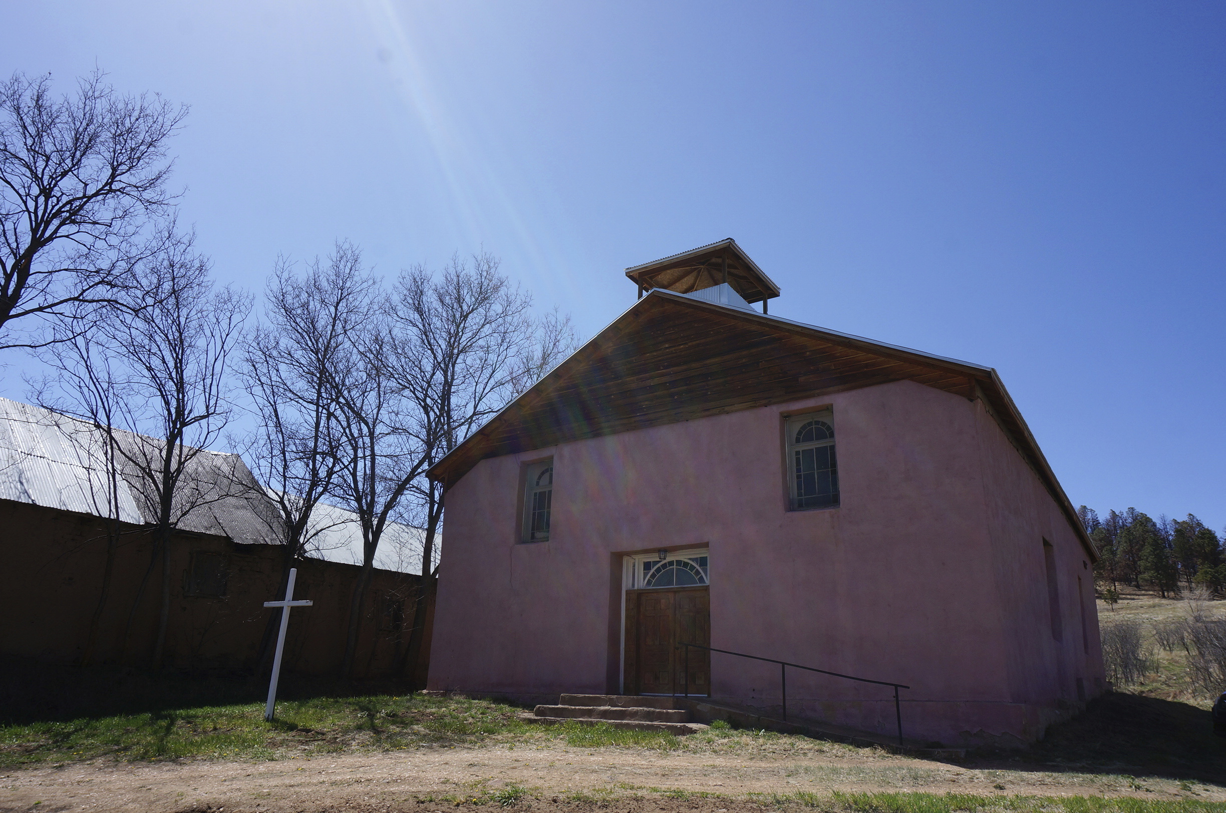 An exterior view of the San Jose Catholic church stands in the hamlet of Ledoux, New Mexico, Saturday, April 15, 2023. Hundreds of historic adobe churches like this survive in northern New Mexico, cared for by