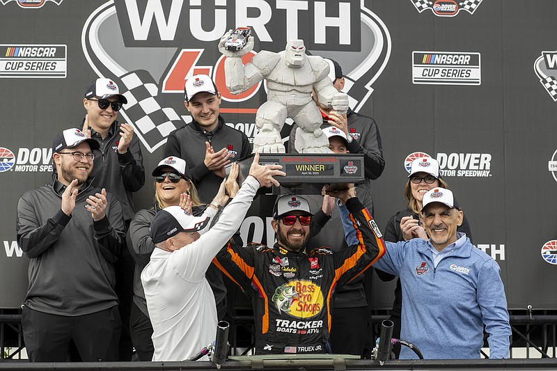 Martin Truex Jr. hoists the trophy after winning the NASCAR 400 auto race at Dover Motor Speedway, Monday, May 1, 2023, in Dover, Del. (AP Photo/Jason Minto)