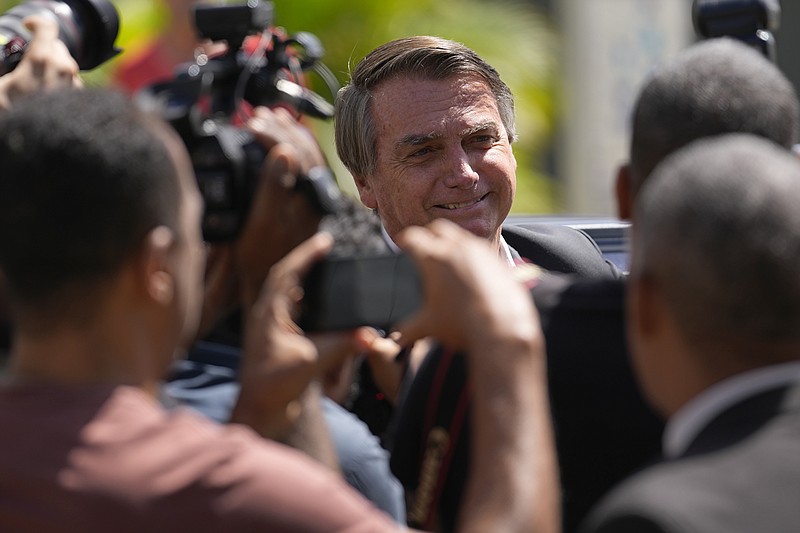Former Brazilian President Jair Bolsonaro leaves Federal Police headquarters after giving testimony over the Jan. 8 attacks in Brasilia, Brazil, Wednesday, April 26, 2023. Thousands of Bolsonaro supporters trashed the presidential palace, the Supreme Court and Congress one week into President Luiz Inácio Lula da Silva's third term in office. (AP Photo/Gustavo Morteno)