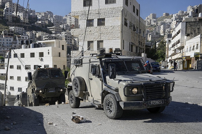 A convoy of Israeli military vehicles drives through the West Bank city of Nablus, during a Thursday raid.
(AP/Majdi Mohammed)