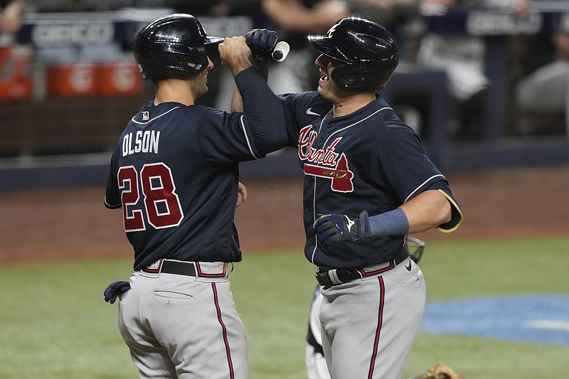 Atlanta Braves Matt Olson (28) celebrates with Austin Riley after he scored on a home run by Riley in the fifth inning of a baseball game against the Miami Marlins, Wednesday, May 3, 2023, in Miami. (AP Photo/Marta Lavandier)