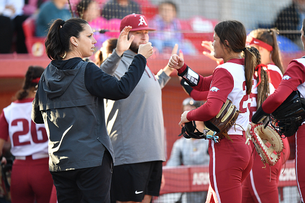 Arkansas coach Courtney Deifel congratulates starter Hannah Camenzind Monday, May 1, 2023, during the Razorbacks’ 2-0 win over Tennessee at Bogle Park in Fayetteville.