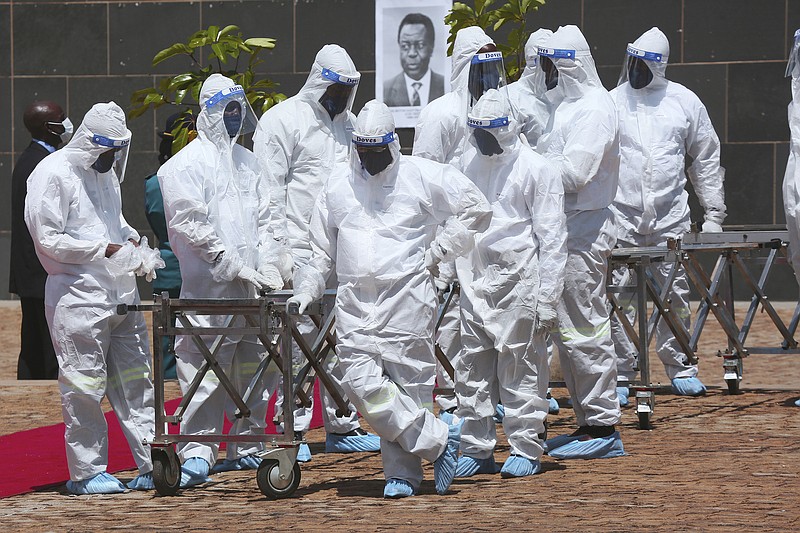 Pallbearers wait for coffins to arrive at a state burial of government ministers who died of covid-19 in Harare, Zimbabwe, in January 2021 as the coronavirus ramped up worldwide.
(AP/Tsvangirayi Mukwazhi)