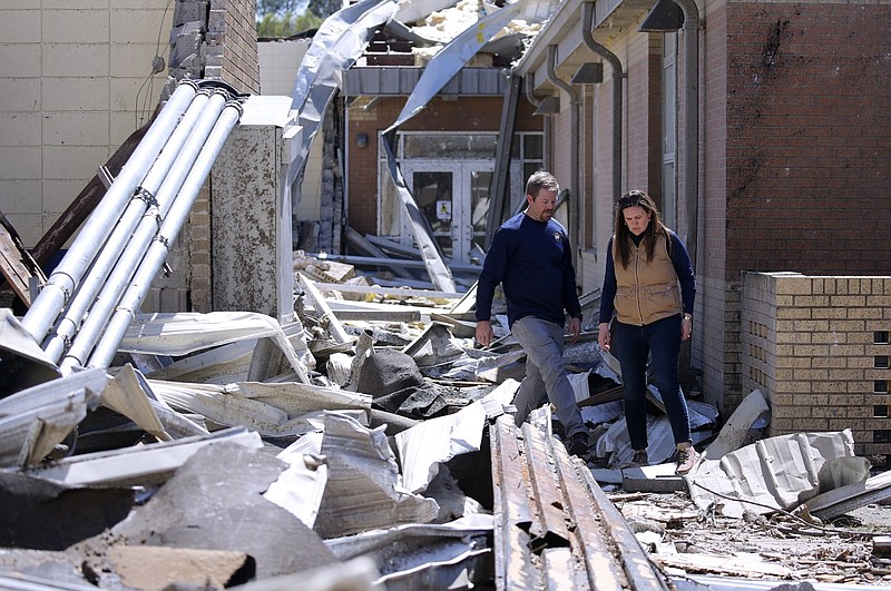 Wynne School District Superintendent Kenneth Moore (left) leads Gov. Sarah Huckabee Sanders through the remains of Wynne High School in this April 2, 2023 file photo. Sanders visited the school in Wynne two days after a tornado swept through the area. (Arkansas Democrat-Gazette/Thomas Metthe)