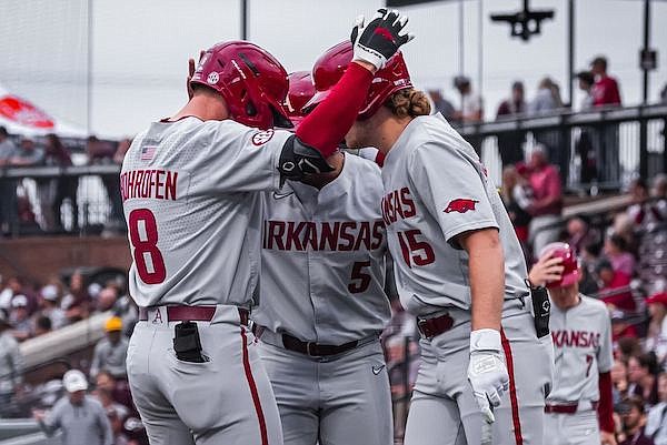 Arkansas center fielder Jace Bohrofen (8) celebrates with teammates after he hit a home run during a game against Mississippi State on Friday, May 5, 2023, in Starkville, Miss.
