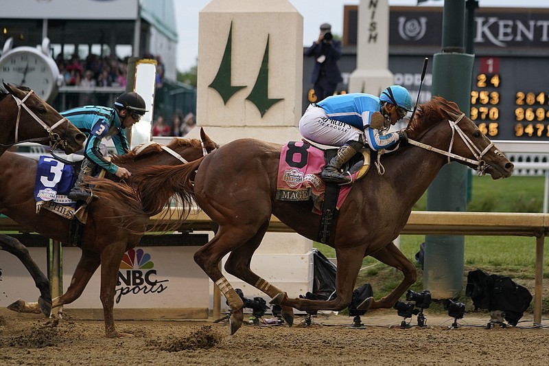 Mage (8), with jockey Javier Castellano, crosses the finish line to win the 149th running of the Kentucky Derby at Churchill Downs in Louisville, Ky., on Saturday, May 6, 2023. (AP/Kiichiro Sato)