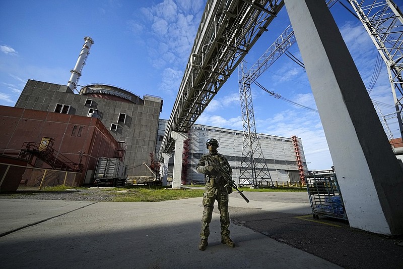 FILE - A Russian serviceman guards in an area of the Zaporizhzhia Nuclear Power Station in territory under Russian military control, southeastern Ukraine, May 1, 2022. The head of the United Nations' nuclear watchdog Rafael Grossi is expressing growing anxiety about the safety of the Zaporizhzhia Nuclear Power Plant, after the governor of the Russia-occupied area ordered the evacuation of a town where most plant staff live amid ongoing attacks in the area. (AP Photo/File)