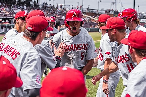 Arkansas right fielder Kendall Diggs (5) is congratulated by teammates after hitting a grand slam during a game against Mississippi State on Sunday, May 7, 2023, in Starkville, Miss.